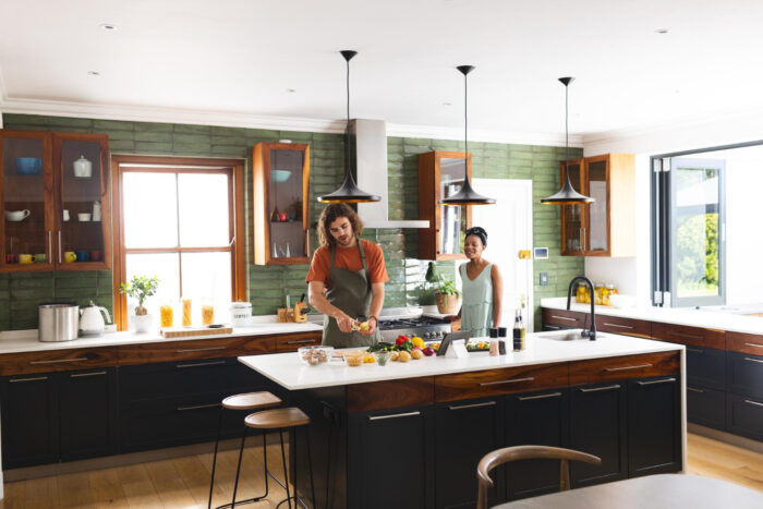 diverse-couple-is-preparing-meal-together-modern-kitchen-with-copy-space Open-concept living remodel inside a Texas family home